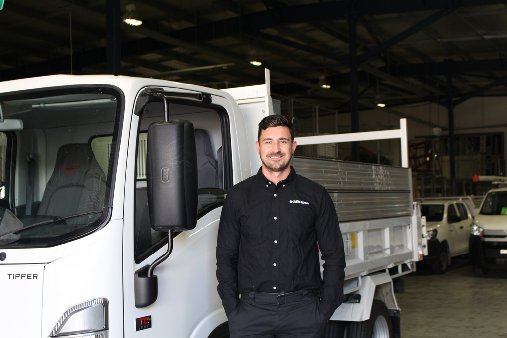 Tim Cullen, TradieSpec CEO, standing by tipper truck